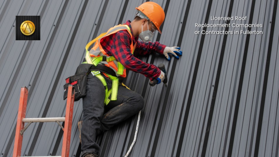A worker in safety gear and an orange helmet uses a power drill on a gray metal roof. A red ladder is nearby, and text reads Licensed Roof Replacement Companies or Contractors in Fullerton.